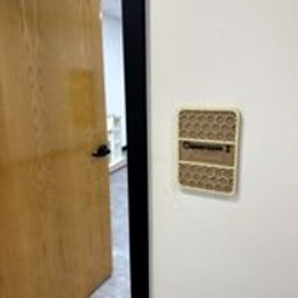 ADA compliant classroom doorway sign with tactile text and Braille