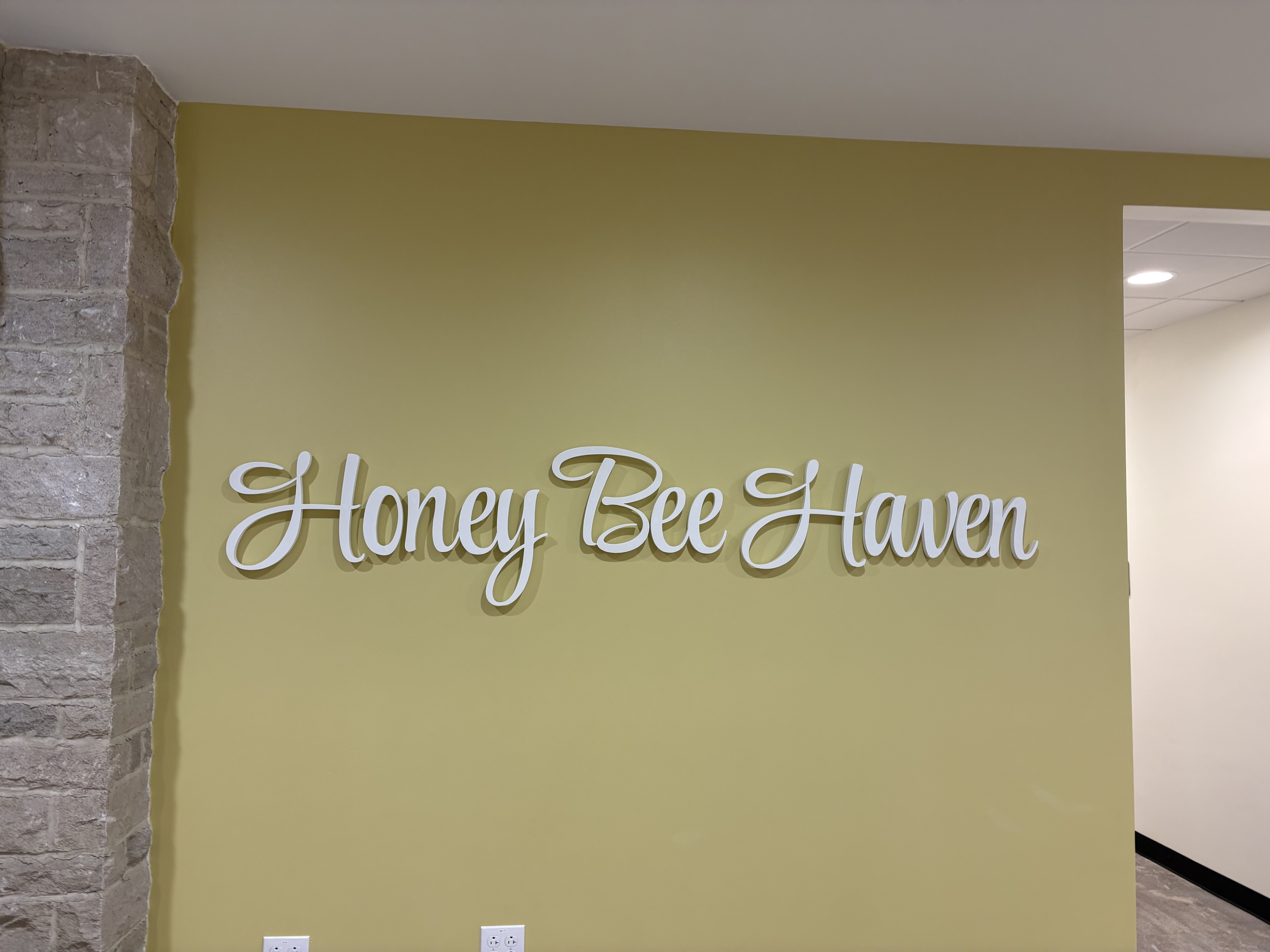 Custom interior wall signage in Pittsburgh featuring dimensional lettering for a commercial space